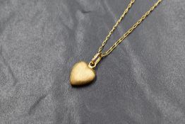A 9ct gold heart shaped pendant having brushed finish on a 9ct gold 16' chain, approx 2.3g