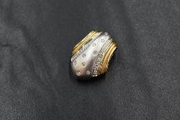 A 14ct two tone gold diamond set pendant, the central matte white gold panel set with nine round