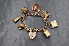 A 9ct gold child's belcher link charm bracelet, having eight charms including kettle, radio, cat and