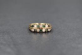 A 9ct gold emerald and cubic zirconia set band, having two rows of alternating round cut emeralds