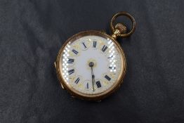 A small 14ct rose gold top wound pocket watch having a Roman numeral dial on a gilt decorated