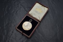 A Victorian silver presentation medal regarding Cunswick Golf Club, Kendal, depicting a golfer on