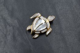 A 14ct gold mother-of-pearl set turtle pendant, the turtle having panels of mother-of-pearl,