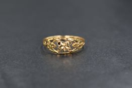 A yellow metal ring stamped 700 having foliate openwork decoration, size Q & 1.2g