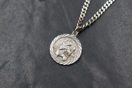 A silver St Christopher pendant having moulded forms of transport en verso, on an 18' silver flat