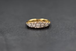 An 18ct gold five stone graduated diamond ring having 5 pave set old cut diamonds, total approx 0.