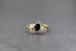 An 18ct gold sapphire & diamond ring, the central oval sapphire of approx 0.5ct in a bezel mount