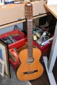 A vintage Hungarian acoustic guitar with soft carry case.