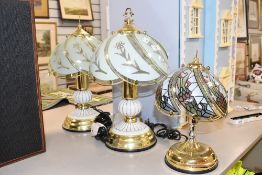 Three Tiffany style lamps including a pair in white and brass effect and a smaller similar