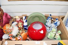A selection of modern figurines, a red art glass vase, a green glass bowl and an autumnal themed