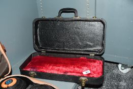 A hardshell instrument case with one red velvet inner cushion (possibly missing another) measuring