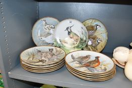 A collection of thirteen striking Franklin Porcelain cabinet display plates in the series