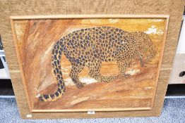 A vintage handcrafted mosaic featuring a Leopard made from banana fibre or bark framed in hessian