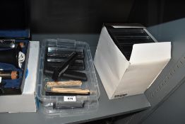 A collection of approximately 45 plastic pen presentation boxes having clear tops and black bases
