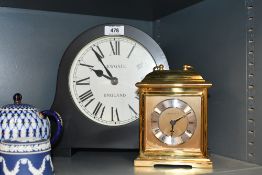A modern Newgate Broadway mantel clock in matt black finish sold along with a brass effect London