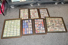 Seven sets of framed cigarette cards having glass to front and rear of frame to include Wills's