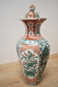 A hexagonal baluster form porcelain covered vase decorated in the Famille Verte style having