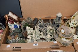 Four aquarium ornaments sold with four assorted resin and ceramic houses etc.