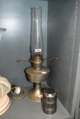 A vintage metal paraffin lamp with glass chimney sold with a Mega porta-light.