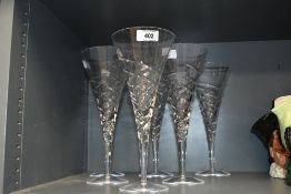 A group of six large modern crystal glass conical form wine/champagne glasses with swirled design,