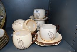 Six vintage Carlton Ware 'Windswept' coffee cups and saucer sets, featuring a cream ivory body