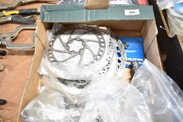 A box of brake discs and various parts