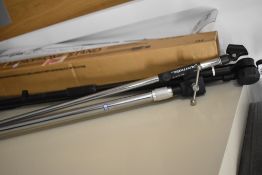 Two microphone stands, Realistic and Stagg, with boxes and clips