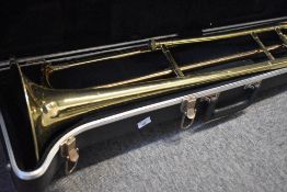 A traditional brass trombone , engraved Blessing USA, quite tarnished condition, with fitted hard