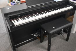 A Technics SX-PX224 digital piano with integral stand cables and stool