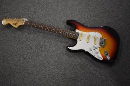 A vintage left handed Stratocaster style left handed electric guitar, headstock printed MI logo,