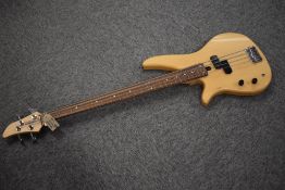 A modern Yamaha left handed bass guitar , model RBX260L , in natural finish