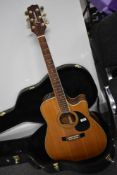 A Takamine EG-334C electro acoustic guitar , with plush lined case