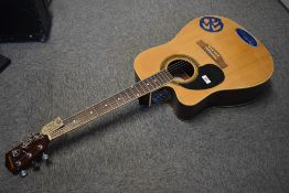 A Johnson JG-624 left handed acoustic guitar, stickers to body