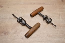 Two early 20th-century spring barrel corkscrews, having a wooden T-handle and a helical spring,