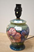 A late 20th-century Moorcroft Pottery 'Clematis' lamp base, feature tube-lined floral detailing upon