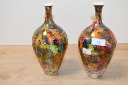 Two contemporary Russell Akerman studio pottery vases, of bottle form, featuring a vibrant multi