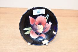 A late 20th-century Moorcroft Pottery 'Orchid' pin dish, featuring tube-lined floral detailing