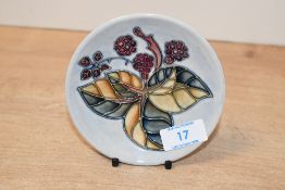 A 20th-century Moorcroft pottery 'Bramble' pin dish after Sally Tuffin, featuring tube-lined