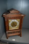 A late 19th-century German Lenzkirch oak mantel clock, featuring an architectural pediment with