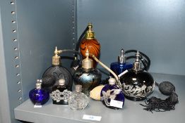 A selection of 20th-century studio glass and similar atomisers, to feature a tall amber and dark