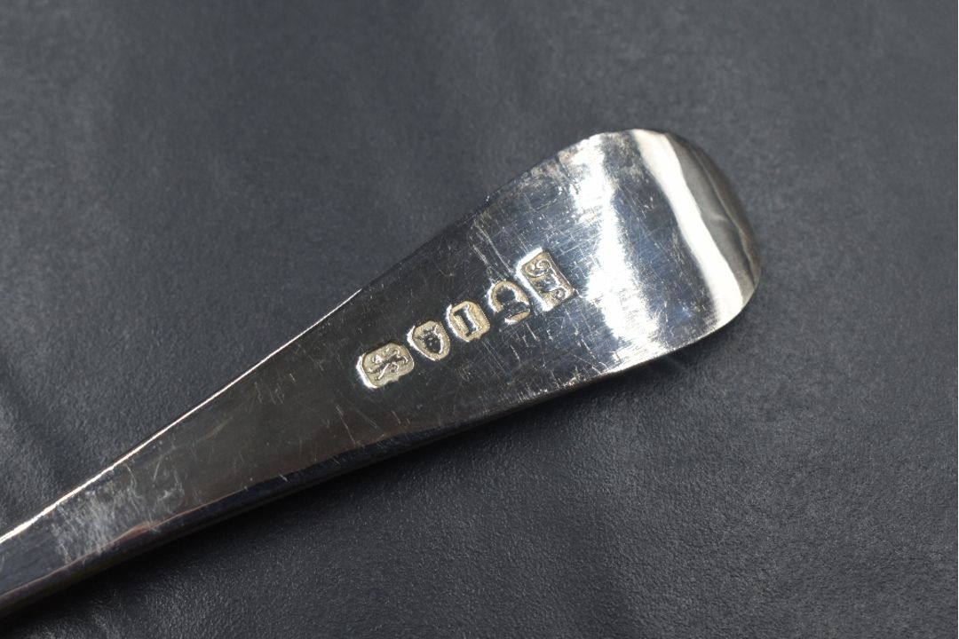 A pair of George III Hanoverian pattern berry spoons having floral ...