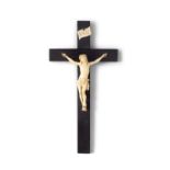 * A FRENCH DIEPPE IVORY CRUCIFIX 19TH CENTURY on ebonised cross, mounted below a scroll plaque