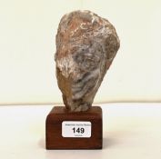 In the style of Emily Young - a carved stone bust, on a wooden plinth  7"h