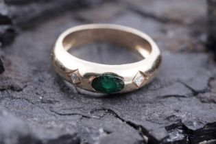 A contemporary emerald and diamond ring