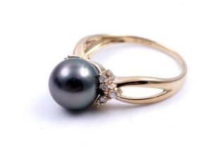 A contemporary cultured black pearl and diamond ring