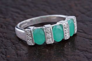 A contemporary emerald and diamond ring