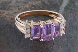 A contemporary amethyst and diamond evening ring