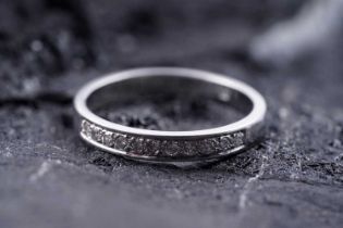 A contemporary diamond half hoop eternity ring