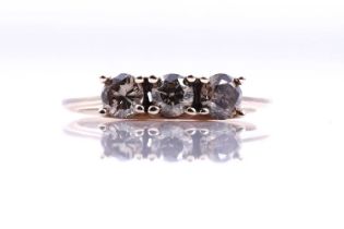 A contemporary three-stone champagne diamond ring