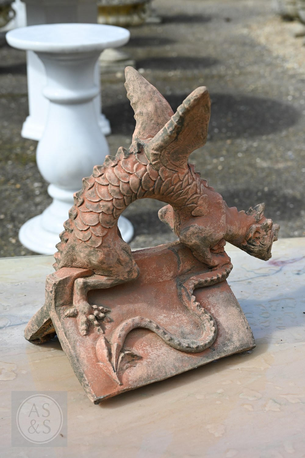 A cast terracotta dragon ridge tile, 47 cm x 43 cm high